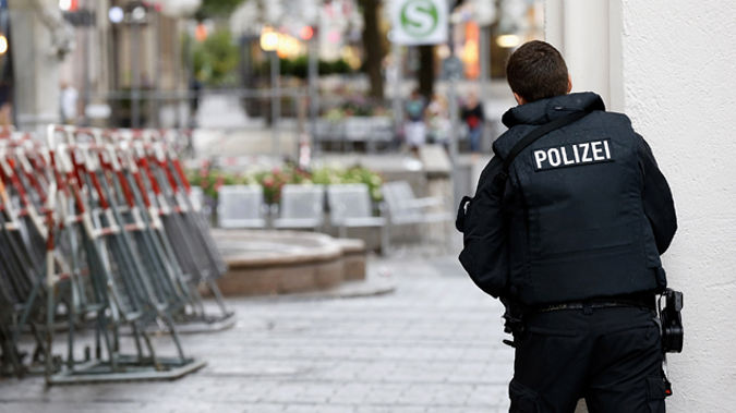 A police officer stands next to a supporter of a right wing demonstration in Dresden, Germany. Photos / Getty Images