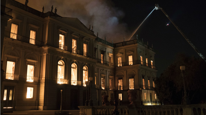Firefighters worked to put out the blaze at the esteemed National Museum in northern Rio. Photo / Wikimedia
