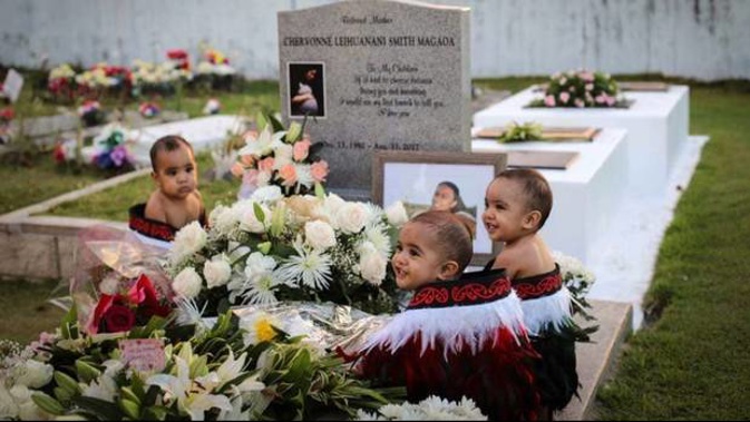 Triplets Blaise (left), Carson and Aayden (far right) Magaoa at the grave of their mother, Chervonne Magaoa. Photo / Supplied