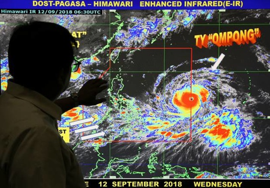 Filipino forecaster Meno Mendoza shows the path of Typhoon Mangkhut. Photo / AP