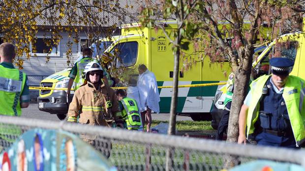 Police and ambulance staff at South End School in Carterton. Students have fallen sick after an unknown substance was dropped from a plane. Photo / Ross Setford