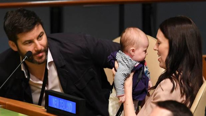 Jacinda Ardern holds her daughter Neve at the United Nations General Assembly flanked by her partner Clarke Gayford. Photo / AFP