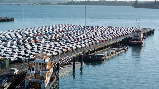 New cars imported from Japan line up on Captain Cook Wharf in Ports of Auckland. Photo / 123RF