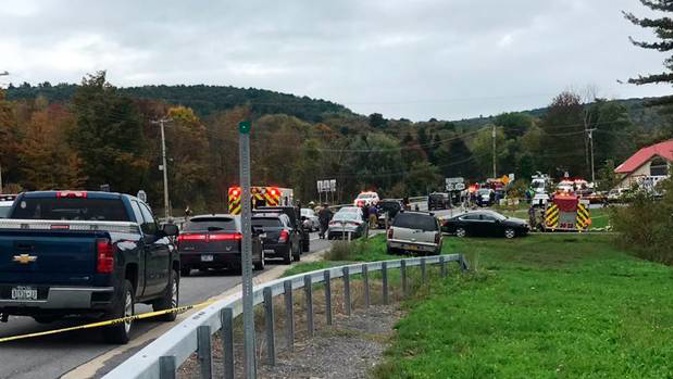 Emergency personnel respond to the scene of a deadly crash in Schoharie, New York, which has left 20 people dead. Photo / AP