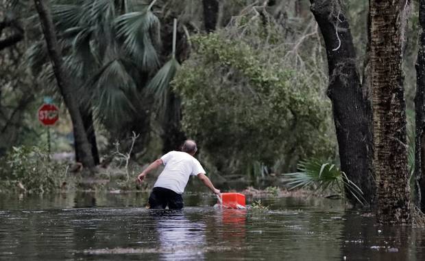 A resident of St. Marks, Florida, rescues a cooler out of the floodwaters near his home. Photo / AP