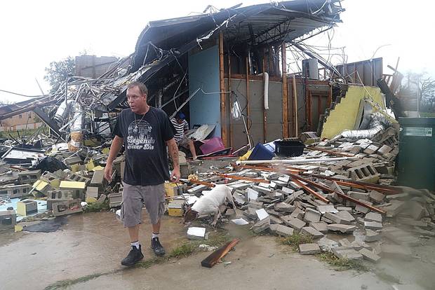 Brian Bon inspects damages in the Panama City downtown area after Hurricane Michael made landfall. Photo / AP