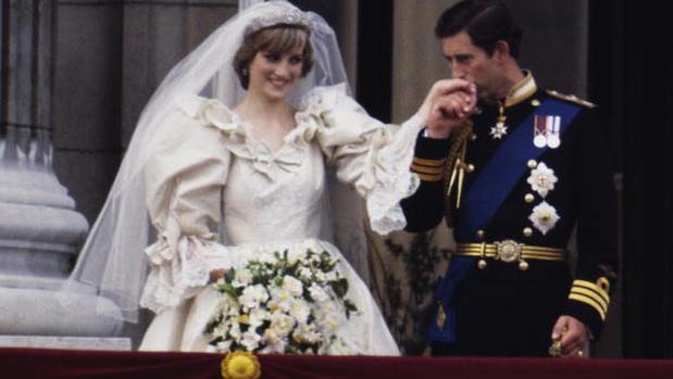 The Prince and Princess of Wales on the balcony of Buckingham Palace on their wedding day. A new biography has revealed Charles wanted to call off the wedding. Photo / Getty Images