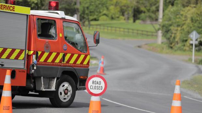 Emergency services at Henderson Valley Rd, in West Auckland, where a motorcyclist was killed. (Photo / Michael Craig)