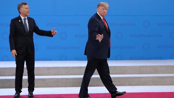 Trump has caused a stir after wandering away from Argentina's President Macri. (Photo / AP)