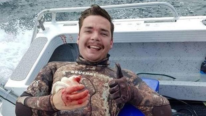Kerikeri's Kevin Lloyd back in the boat after being attacked by a shark while spearfishing near the Cavalli Islands. Photo/Supplied