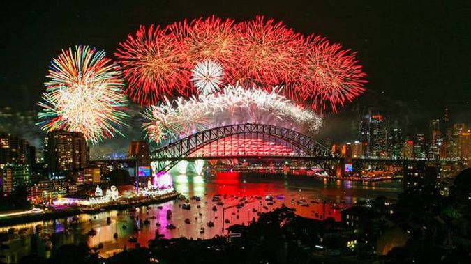 Fireworks explode over the Sydney Harbour Bridge during the midnight display on New Year's Eve on Sydney Harbour. Photo / Getty