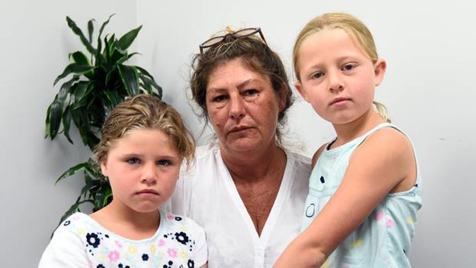Linda Valentine with granddaughters Sadie, 6, and Allarose Kaye, 7, who was pricked by a hypodermic needle while walking through Memorial Park. (Photo / George Novak)