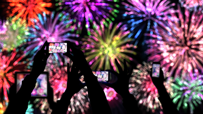 People are spending more time on their phones on New Year's Eve. (Photo / Getty)