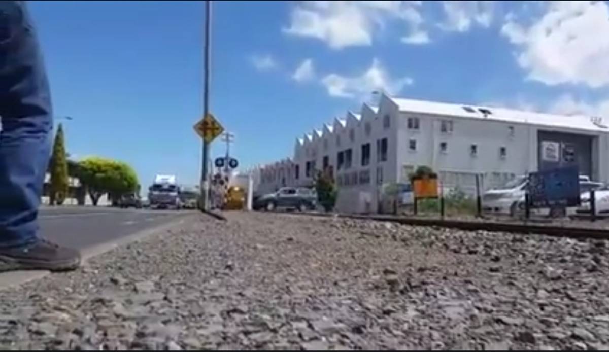 The ute crosses the track just a few seconds before the train comes down the line. (Video: Supplied)