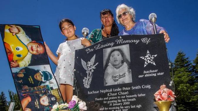 Keiarah Nathan-Craig, 9, left, Teresa Smith-Craig and Nana Anne Craig at Isachaar's grave at Mangaroa Cemetery near Hastings where his pounamu was stolen from. (Photo / Paul Taylor)