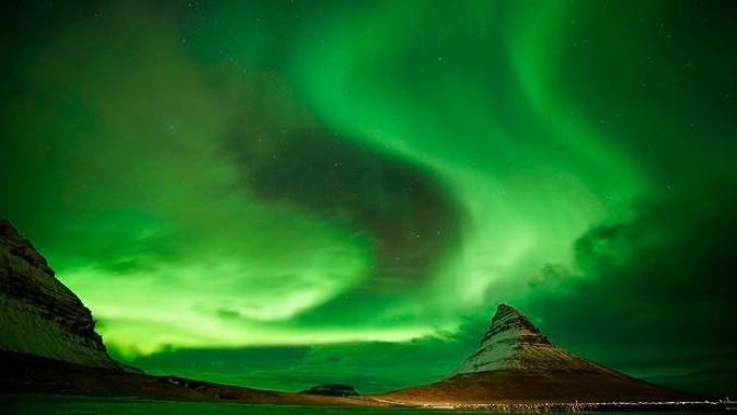 Aurora Borealis, the Northern Lights, over Kirkjufell. The aurora is caused by charged particles from the Sun being captured by Earth's magnetic field. (Photo / Getty)