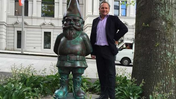 Gow Langsford Gallery director John Gow pictured with the 2m tall bronze Gnome statue which was stolen over the Christmas holidays. Photo / Supplied