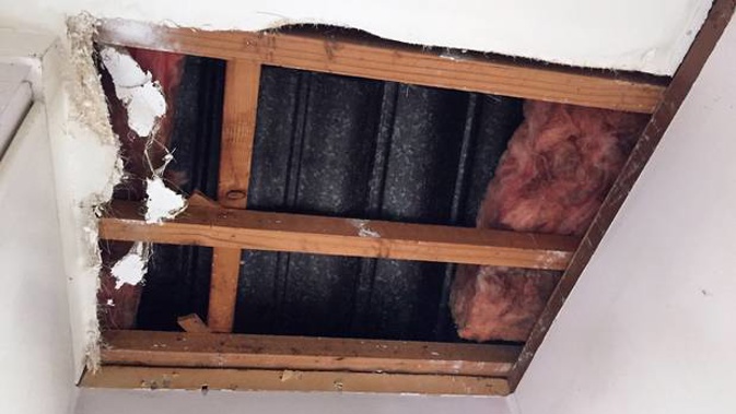 The hole left in the ceiling of 82-year-old Greenlane woman Heidrun Leonard's house by two people who scammed her out of $8800. (Photo / Ben Leahy)