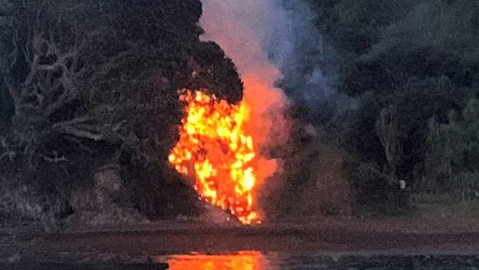 Flames shoot into the sky seconds after the explosion at Rangihoua Bay. Photo / Vanessa Owen