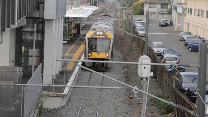 A train sits at Mt Albert Station after all Auckland trains were suspended this morning. Photo / Michael Craig