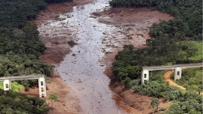 The dam collapsed yesterday, engulfing a nearby village in millions of cubic metres of mining waste. (Photo / AP)