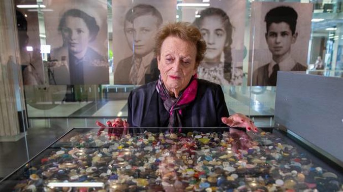 Pictured is holocaust survivor Inge Woolf viewing some of the 1.5 million buttons, representing the number of Jewish children murdered in the Holocaust. Photo / Mark Mitchell