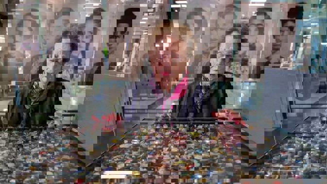 Pictured is holocaust survivor Inge Woolf viewing some of the 1.5 million buttons, representing the number of Jewish children murdered in the Holocaust. Photo / Mark Mitchell