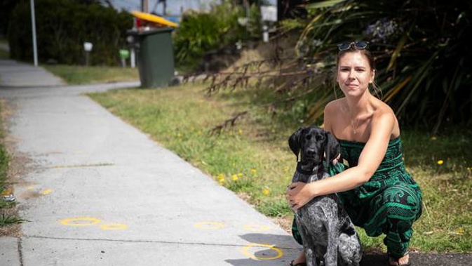 AJ Hodges with her dog Wilson on Clayburn Rd in Glen Eden, where a number of people were injured after a collision with a car outside a party on Sunday morning. (Photo / Jason Oxenham)