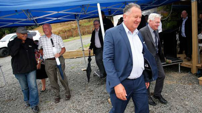 Northland regional transport committee chairman John Bain (second from left) and Regional Economic Development Minister Shane Jones (front) managed a chuckle after tense words. (Photo / Michael Cunningham)