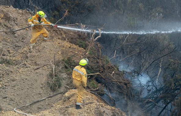 A risk of flare-ups is keeping people out of their homes for another day. (Photo / NZ Herald)