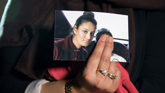 Renu Begum the eldest sister of Shamima Begum holds her sister's photo. Photo / Getty Images