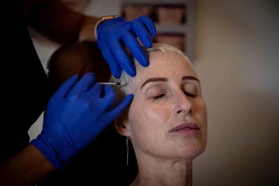 Former finance manager Trish Wakelin found herself struggling to add basic maths, stumbling and passing out from migraines - her only relief is Botox. (Photo/Dean Purcell)