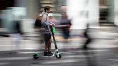 An Aucklander riding a Lime e-scooter around the city. (Photo / Greg Bowker)