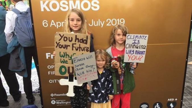 Finn, 10, Brodie, 7, Tara, 3 at today's climate strike in Wellington. Photo / Devon Bolger