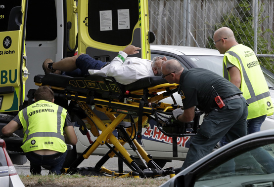 A victim of the shooting is taken away by ambulance. (Photo / AP)