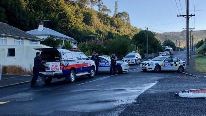 Police outside an address in Somerville St, Dunedin. Photo / ODT