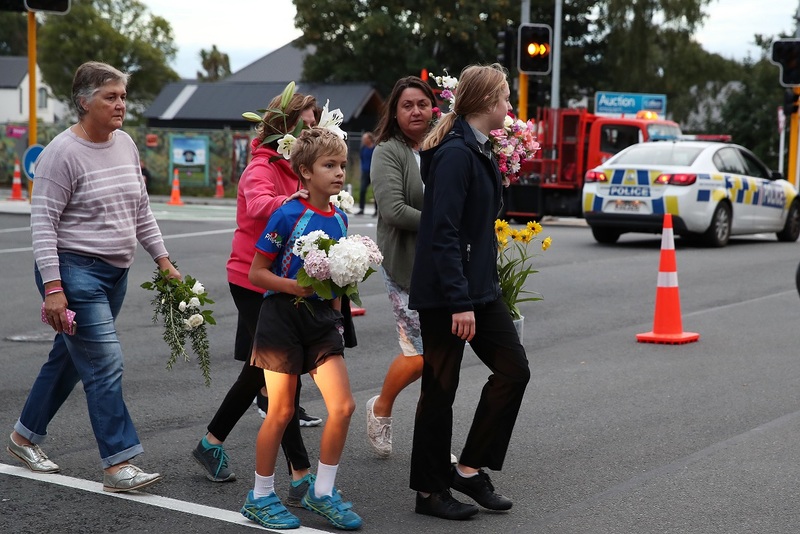People lay flowers at the cordon on Deans Ave in Christchurch. Photo / Getty Images