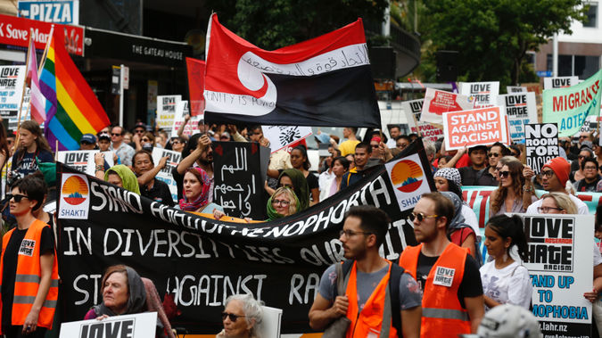 People walk through Auckland during the March for Peace. (Photo / Dean Purcell)