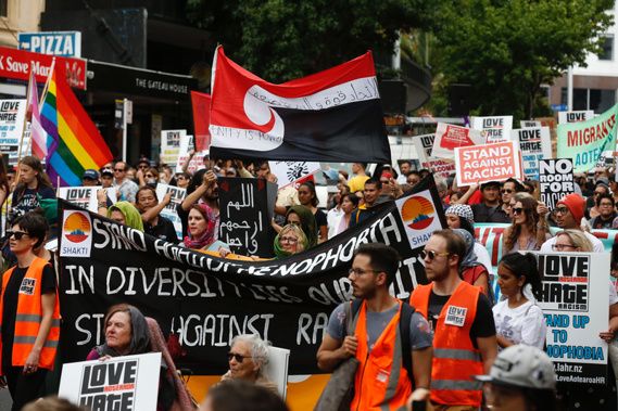 People walk through Auckland during the March for Peace. (Photo / Dean Purcell)