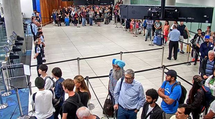 Customs officers formed a human barrier to close off borders at Auckland International Airport during the two minutes' silence last Friday. (Photo / supplied)
