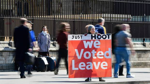 A supporter of Brexit holds a sign outside the Houses of Parliament in Westminster. Photo / AP