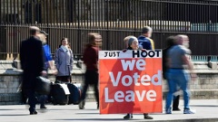 A supporter of Brexit holds a sign outside the Houses of Parliament in Westminster. Photo / AP
