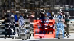 A supporter of Brexit holds a sign outside the Houses of Parliament in Westminster. Photo / AP