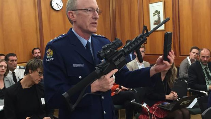 Police acting superintendent Mike McIlraith demonstrates to a select committee in Parliament the types of weapons and magazines that will be banned under the new guns legislation. (Photo / NZME)