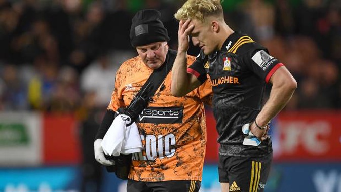 A dejected Damian McKenzie after being injured against the Blues. Photo / Photosport