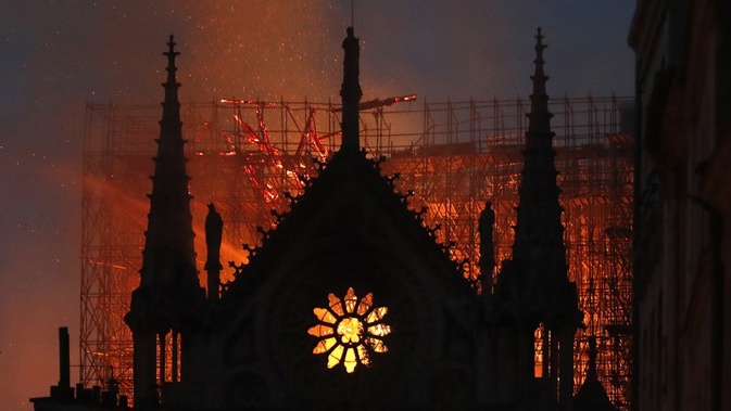 The famous Paris cathedral has been virtually destroyed in a massive blaze - its roof and spire have collapsed. 