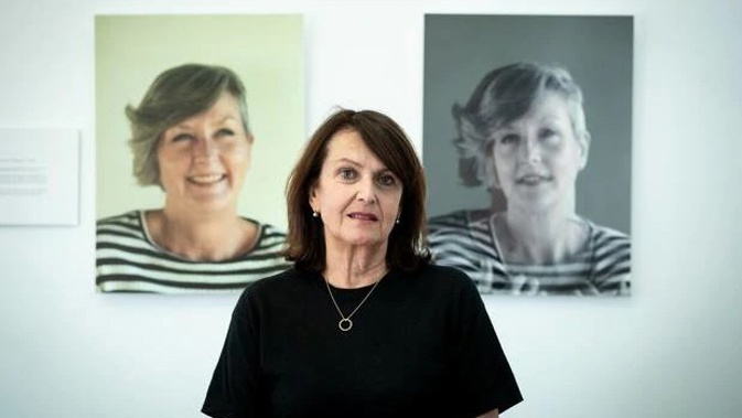 Sweet Louise chief executive Philippa Reed stands in front of images of Anna Southern, who was one of 100 members if the support group who have died since last October. Photo / Dean Purcell