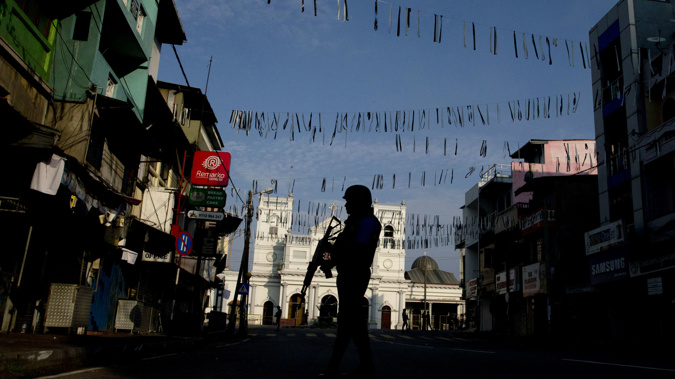 A security officer stands guard outside St. Anthony's Shrine where bombing was carried out on Easter Sunday. (Photo / AP)