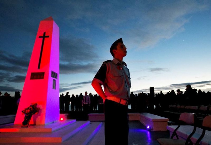 A member of the honour guard stands to attention at the cenotaph overlooking the beach at Mt Maunganui. Photo / Alan Gibson
