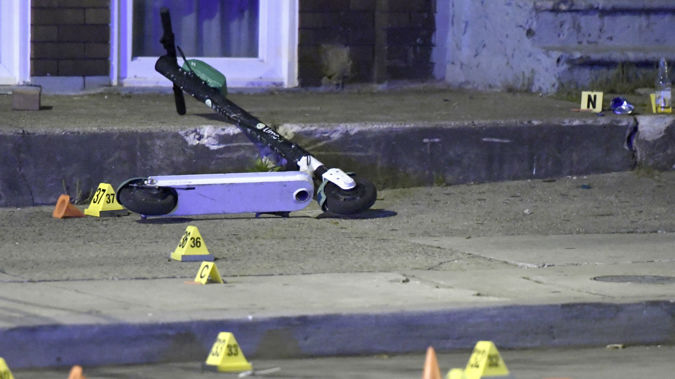 A scooter lies in the middle of the crime scene. (Photo / AP)